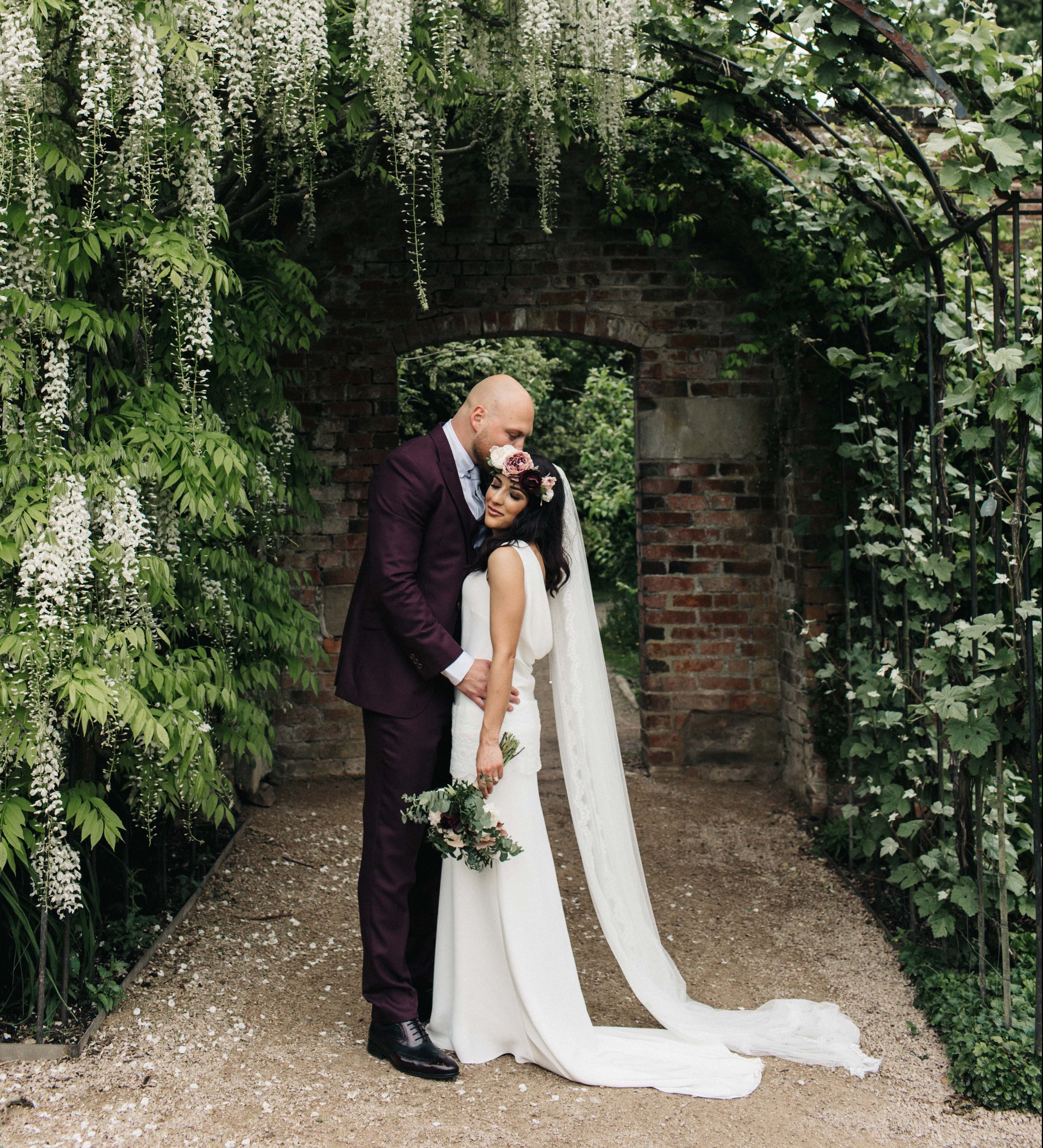 Real Bride Giulia wears Sada by Charlie Brear -Bride & Groom floral arch